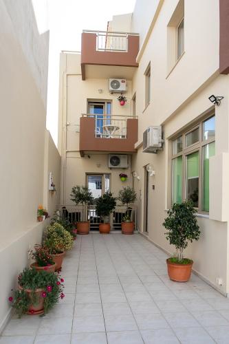 a courtyard of a building with potted plants at Rania Studios in Gouves