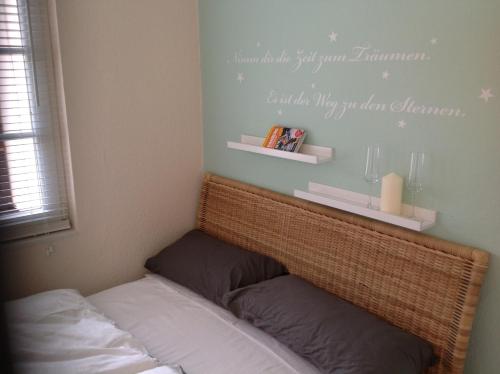 a bedroom with a bed with a sign on the wall at Apartment Base in Hamburg