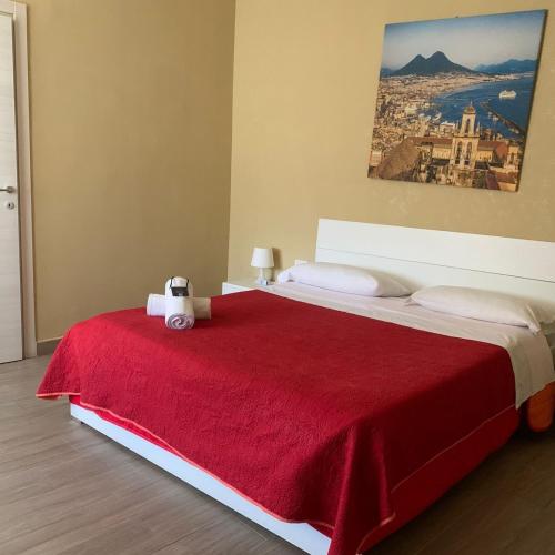 a bedroom with a large bed with a red blanket at Royal Dante in Naples