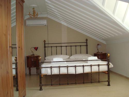 a bed in a room with a white ceiling at Merlot Village Rental Properties in Kariá
