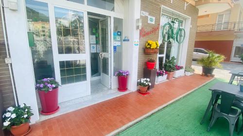a front door of a house with potted plants on it at Hotel Principe in Pietra Ligure