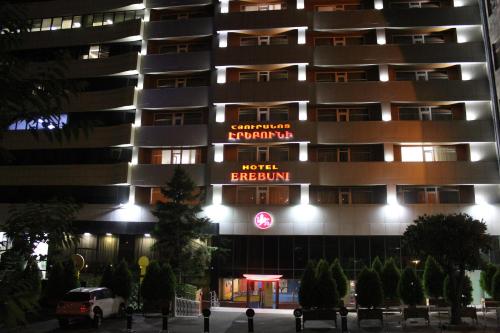 a hotel at night with neon signs on it at Erebuni Hotel Yerevan in Yerevan