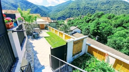 a balcony of a house with a view of a mountain at vallemaira house CASA BELVEDERE LUCE & SOLE 10 POSTI LETTO in San Damiano Macra