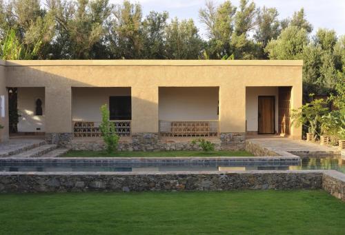 a building with a pond in front of it at Dar al Hossoun in Taroudant