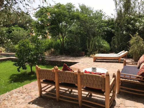 a patio with a table and chairs in a garden at Dar al Hossoun in Taroudant