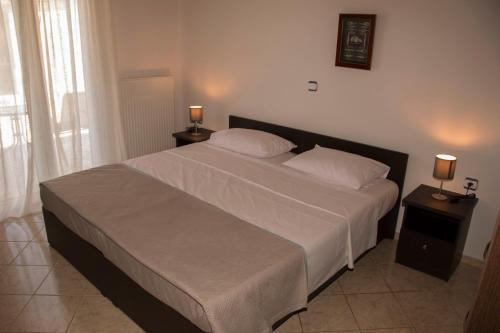 a bedroom with a large bed with two night stands at Villa Erofili Plakias south Rethimno Crete in Asómatoi