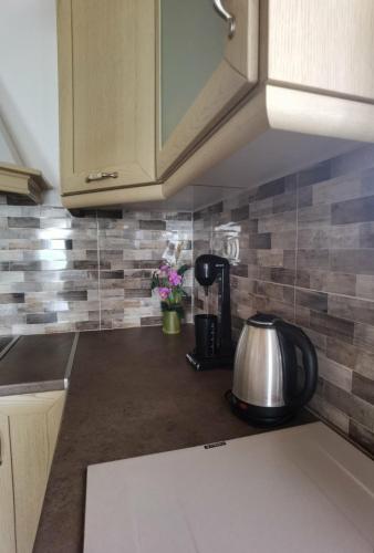 a kitchen counter with a coffee maker on a counter top at GIALOS APARTMENT in Elafonisos