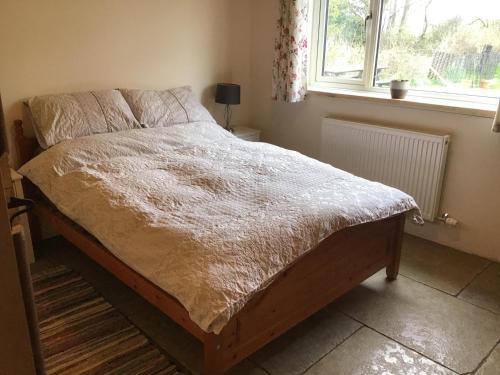 a bed sitting in a bedroom with a window at Beautiful 1-Bed Lodge in Clifford Hereford in Hereford