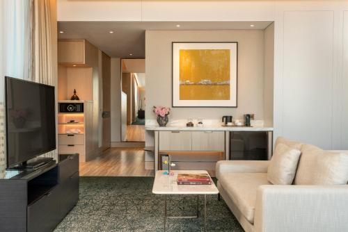 a living room with a couch and a tv at Address Istanbul in Istanbul