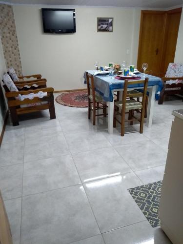 a dining room with a blue table and chairs at Casa e Flat Conforto Gramado in Gramado