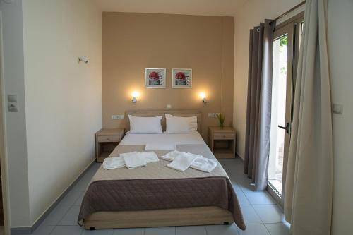 a bedroom with a bed with towels on it at Rania Studios in Gouves