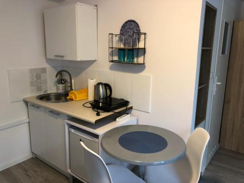 a small kitchen with a table and a sink at MORSKIE FALE in Kołobrzeg