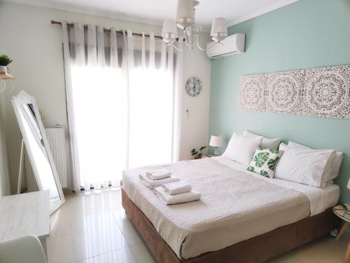 a bedroom with a large bed with two towels on it at City Center Fresh Studio #Self Check In# in Thessaloniki