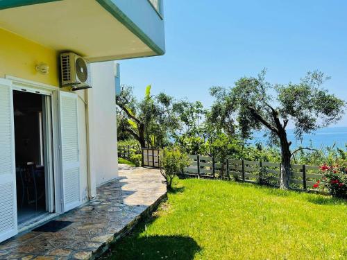 a house with a yard with a fence at Triantis Apartments in Ligia