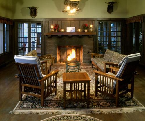 a living room with chairs and a fireplace at Banning House of Two Harbors in Two Harbors
