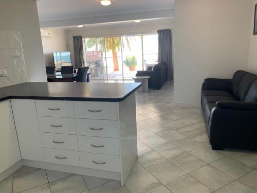a living room with a counter and a couch at Beachside & Jetty View Apartment 6 - Captain's Apt in Streaky Bay