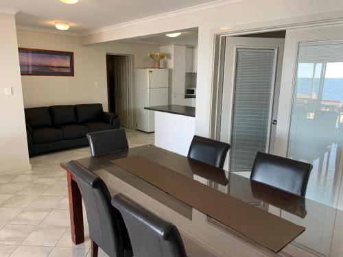 a dining table and chairs in a living room at Beachside & Jetty View Apartment 6 - Captain's Apt in Streaky Bay