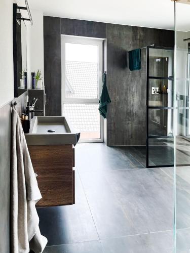 a bathroom with a sink and a glass shower at The View Suite in Brücktal