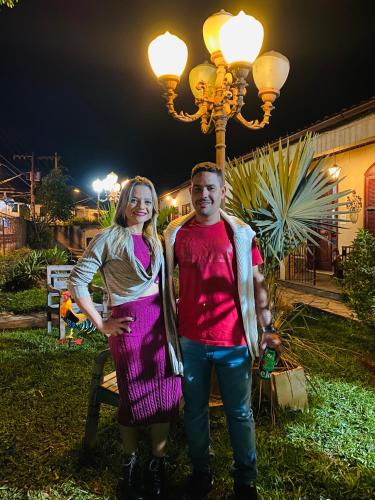 a man and a woman standing next to a street light at POUSADA CHARLOTTE in Tiradentes