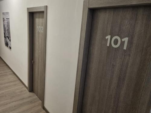 a wooden elevator door with the number on it at Hotel Sole in Eraclea Mare