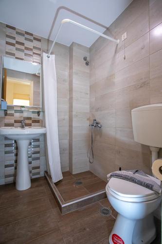 a bathroom with a toilet and a sink at Rania Studios in Gouves