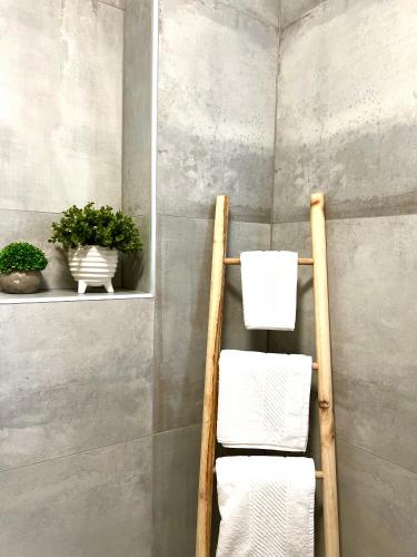 a towel rack with towels on it in a bathroom at Apartmani CUBE L in Medulin