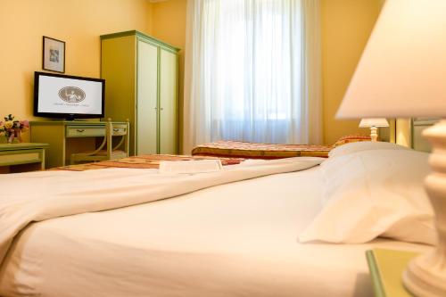 Postel nebo postele na pokoji v ubytování Hotel Minerva