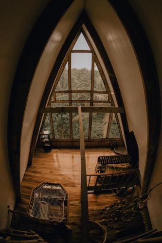 a large window in a room with a wooden floor at Camiguin Volcano Houses - A-Frame house in Mambajao