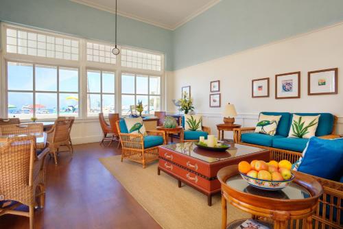 a living room with blue couches and a table at Pavilion Hotel in Avalon