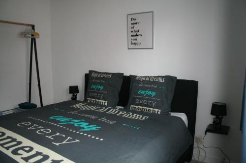 a bedroom with a bed with pillows on it at Vakantiehuis Martien in Peer