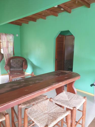 a wooden table and chairs in a room at Seawind Cottage Authentic St.Lucian Accommodation near Plantation Beach in Gros Islet