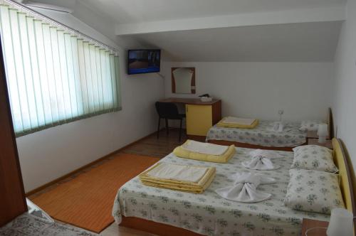 a room with two beds and a table in it at Yanis in Chernomorets