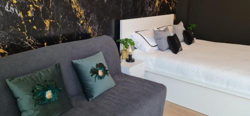 a living room with a couch and a bed at TokiTakai Collection in Padova
