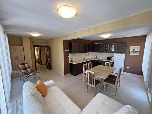 a living room with a white couch and a table at Valemar Apartments in Pomorie