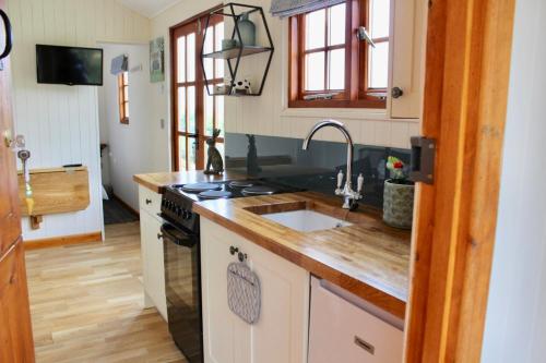 a kitchen with a sink and a stove at Hare's Hut in Saint Clement