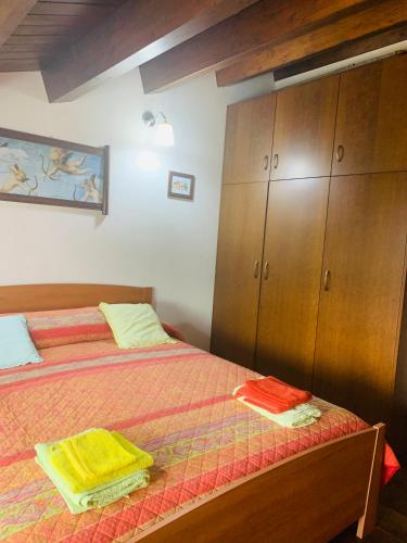 a bedroom with two beds and wooden cabinets at Il Casale di Luisa in Modica