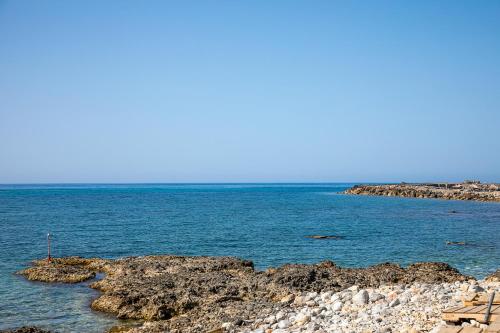 a view of the ocean from a rocky shoreline at Rania Studios in Gouves