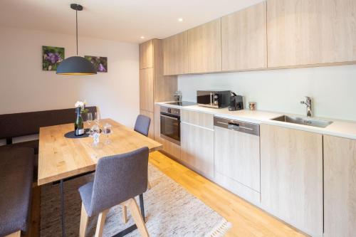 a kitchen with wooden cabinets and a wooden table at Haus Amatschon in Brand
