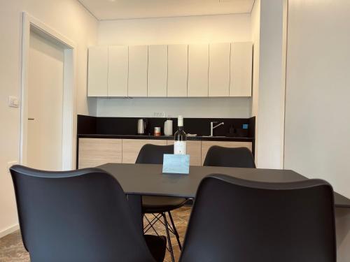 a conference room with a table and black chairs at Zaro Apartments in Izola