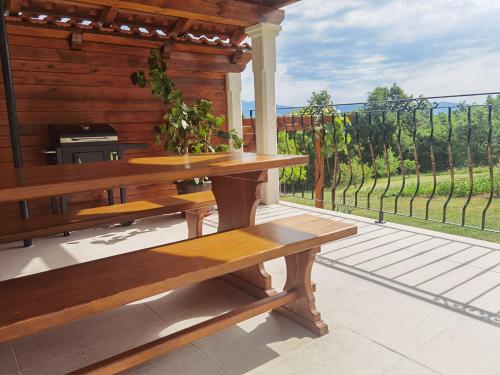 a wooden bench sitting on a patio with a view of aestead at Apartment Luce in Pićan