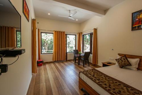a bedroom with a bed and a table and chairs at Bajoon homestay in Bhīm Tāl