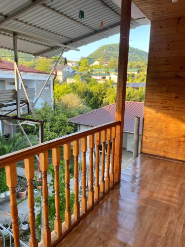 a view from the balcony of a cabin with a wooden railing at At Alla's in Novy Afon