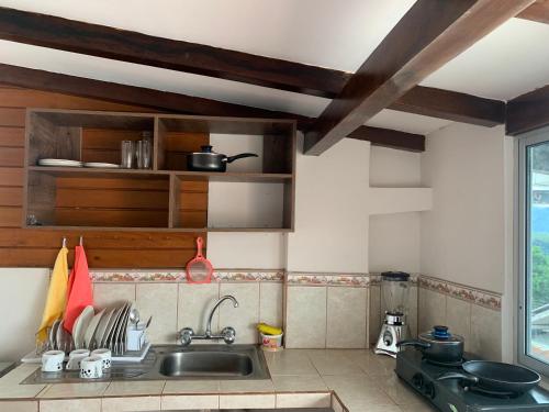 a kitchen with a sink and a window at MY HOUSE IN MACAS, SUITE AMOBLADA in Macas