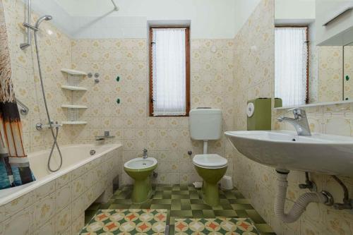 a bathroom with a sink and a toilet and a tub at Apartment in Porec/Istrien 10190 in Poreč