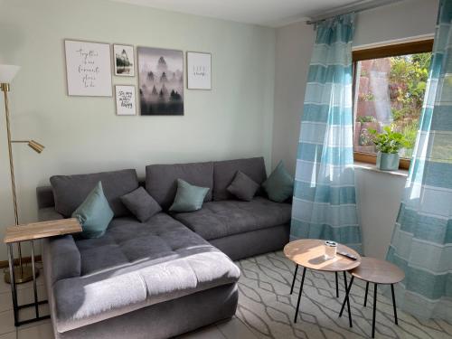 a living room with a couch and a table at Haus Bärbel in Geisfeld