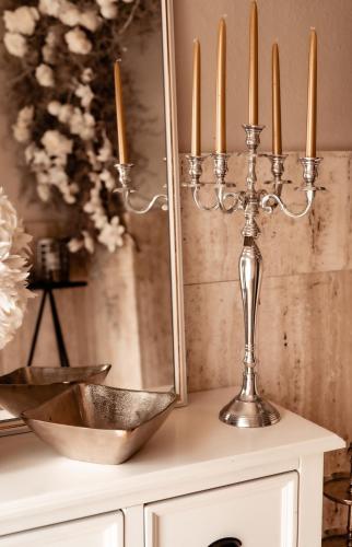 a candelabra with three candles on a table at Boutique Hotel Villa Monika in Westerland (Sylt)