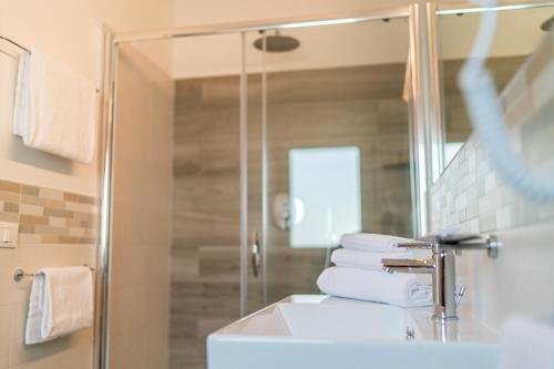 a bathroom with a sink and a mirror at Hotel Centrale in Lignano Sabbiadoro