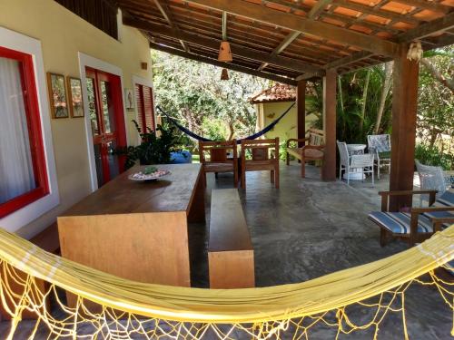 a hammock in the middle of a living room at Sitio Ilha do Meio in Itacimirim
