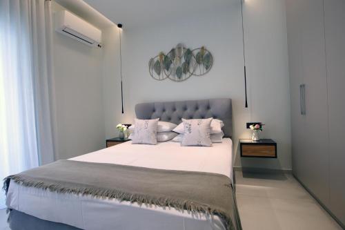 a bedroom with a large bed with white sheets and pillows at Ioanna's Suite in Nafplio