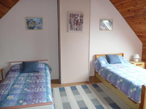 a bedroom with two beds in a room at Holiday Home in Plouarzel near Sandy Beach in Plouarzel